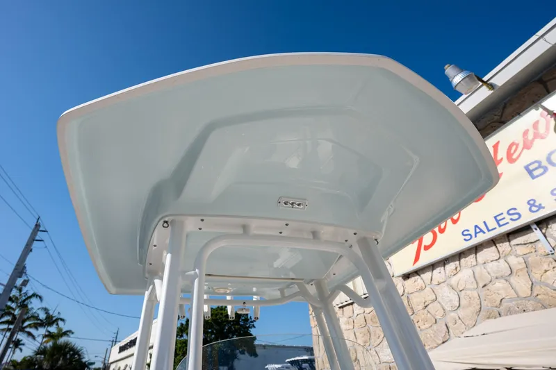 Slide: The Image of 2022 Robalo R242 boat T-top against clear blue sky. - 21