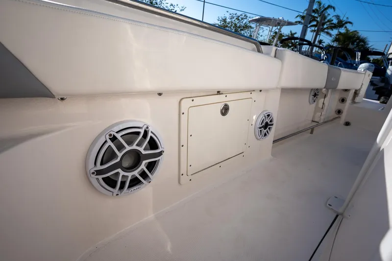Slide: The Image of 2022 Robalo R242 boat interior with speakers and storage compartment. - 22