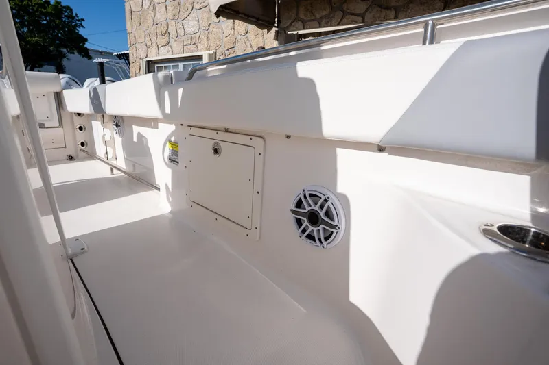 Slide: The Image of 2022 Robalo R242 boat interior with speaker and storage compartment. - 23