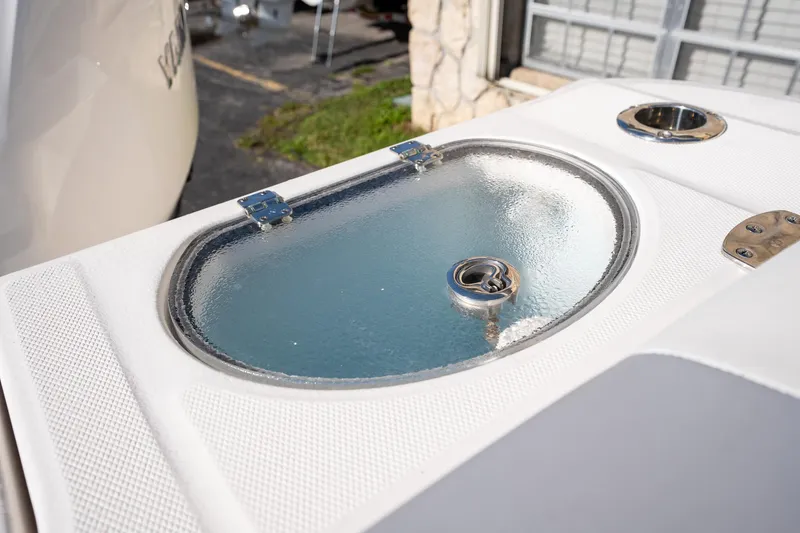Slide: The Image of 2022 Robalo R242 boat livewell with clear lid and stainless steel fittings. - 29