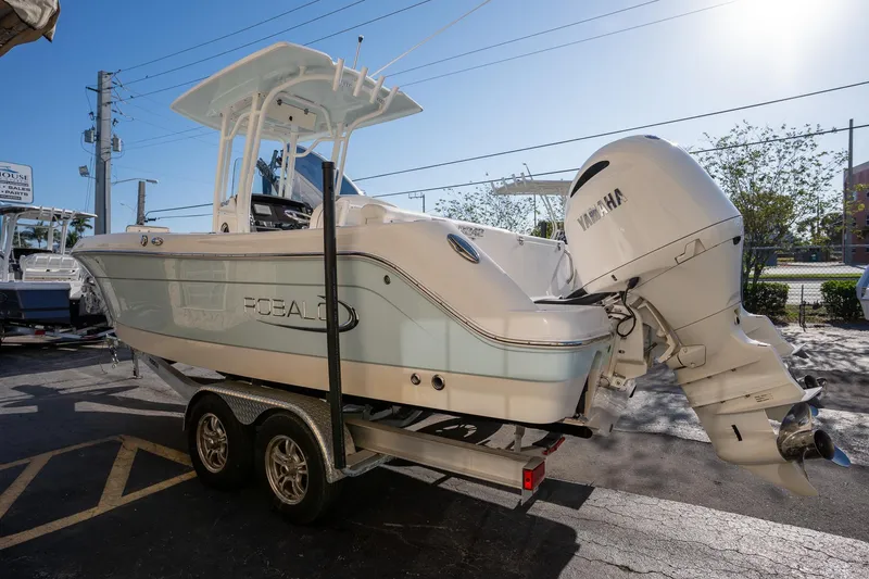 Slide: The Image of 2022 Robalo R242 boat on trailer with Yamaha outboard motor, parked outdoors. - 32