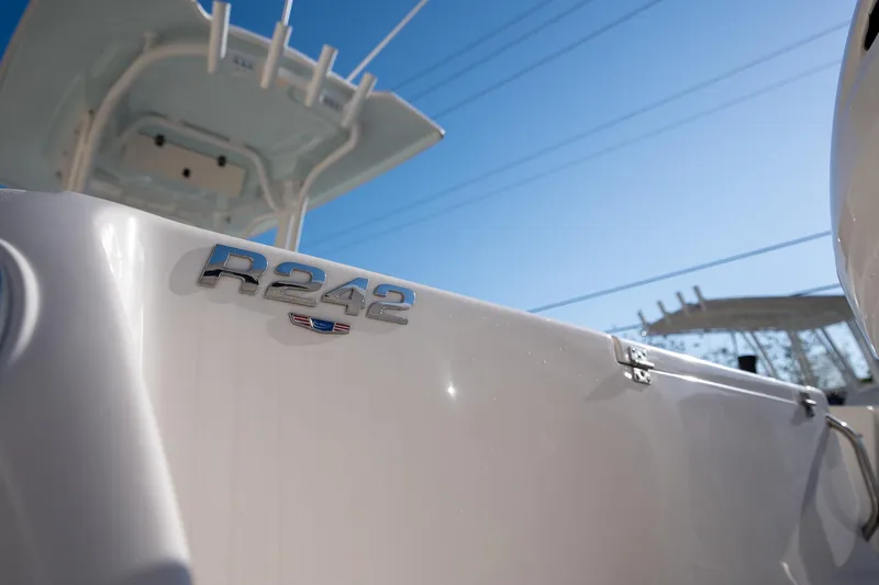 Slide: The Image of 2022 Robalo R242 boat close-up with clear blue sky background. - 33