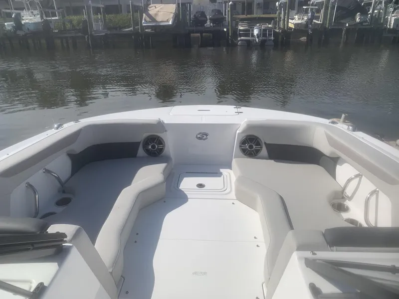 Slide: The Image of 2025 Hurricane SD 2050 boat interior with seating and speakers, docked by the water. - 4