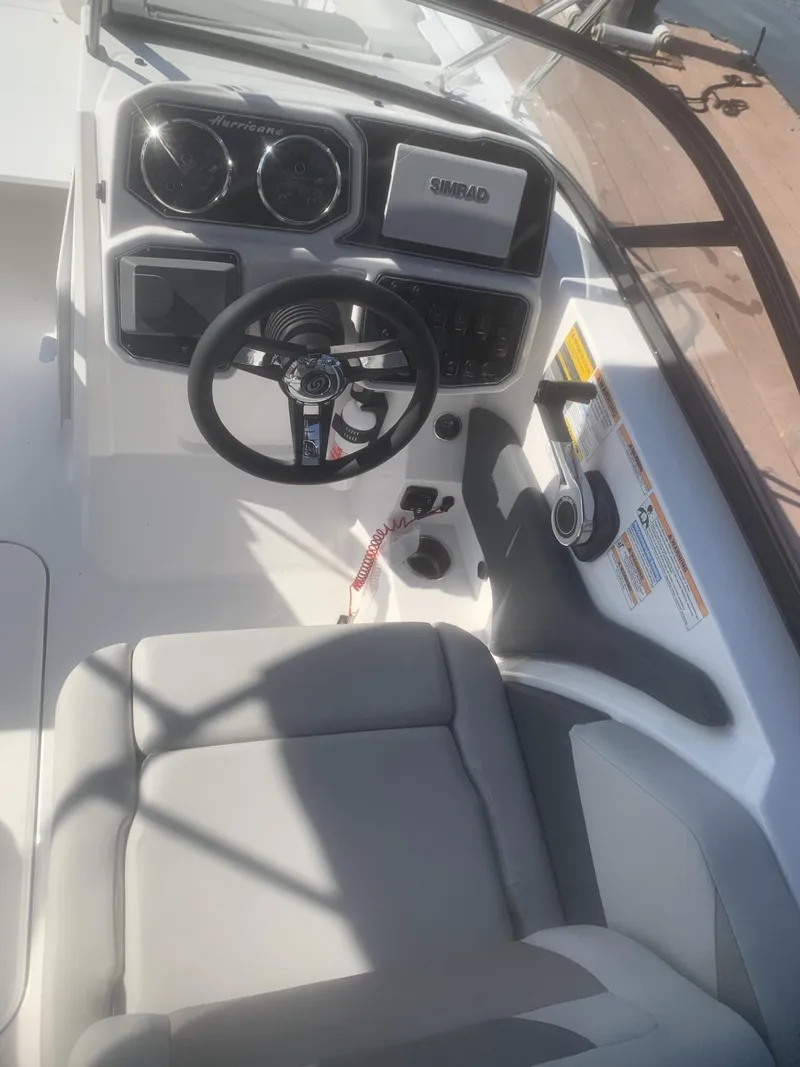 Slide: The Image of 2025 Hurricane SD 2050 boat cockpit with steering wheel and dashboard controls. - 7