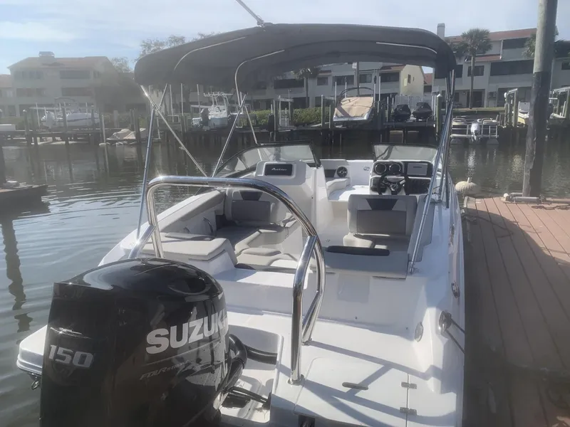 Slide: The Image of 2025 Hurricane SD 2050 boat docked, featuring a Suzuki 150 outboard motor and spacious seating. - 8