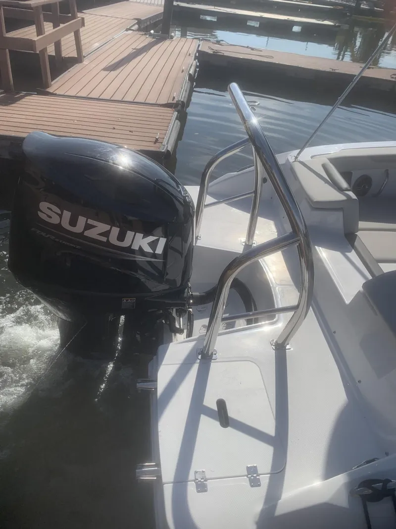 Slide: The Image of 2025 Hurricane SD 2050 boat with Suzuki outboard motor at dock. - 9
