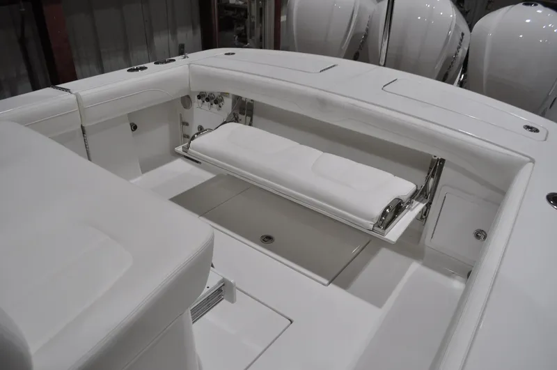 Slide: The Image of 2023 Regulator 34 boat interior with foldable seating and sleek white design. - 10
