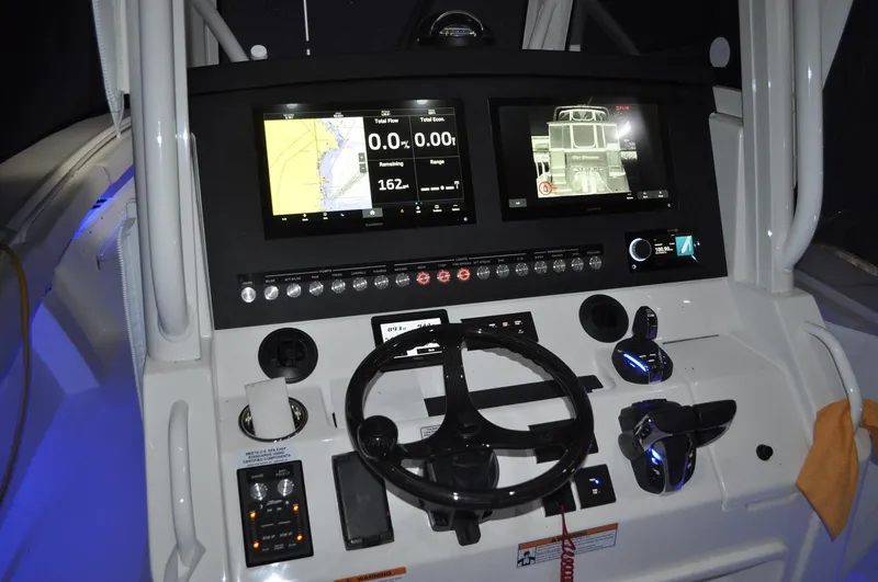 Slide: The Image of 2023 Regulator 34 boat dashboard with dual displays and steering wheel. - 15