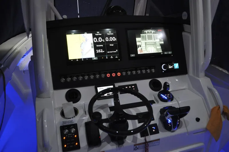 Slide: The Image of 2023 Regulator 34 boat dashboard with dual screens and controls. - 16