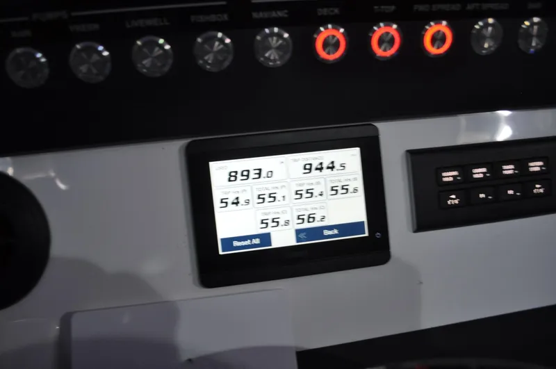 Slide: The Image of Control panel of 2023 Regulator 34 boat with digital display and buttons. - 17