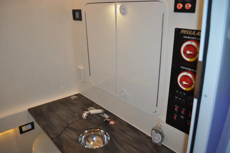 Slide: The Image of 2023 Regulator 34 boat interior with control panel and sink. - 24