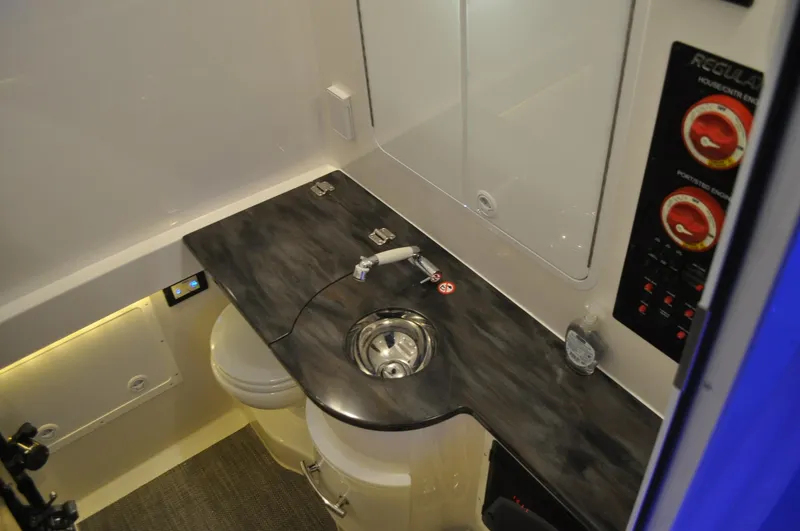 Slide: The Image of 2023 Regulator 34 boat interior with sink, control panel, and modern amenities. - 25