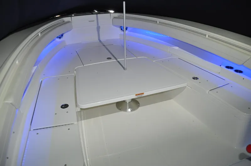 Slide: The Image of 2023 Regulator 34 boat interior with blue LED lighting and central table. - 29