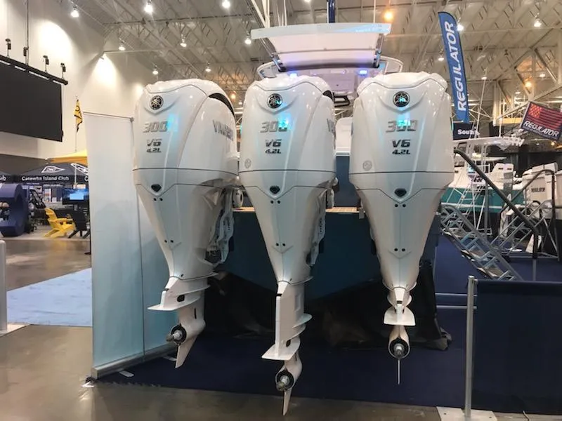 Slide: The Image of Triple Yamaha V6 outboard engines on a 2023 Regulator 34 boat at a marine exhibition. - 31