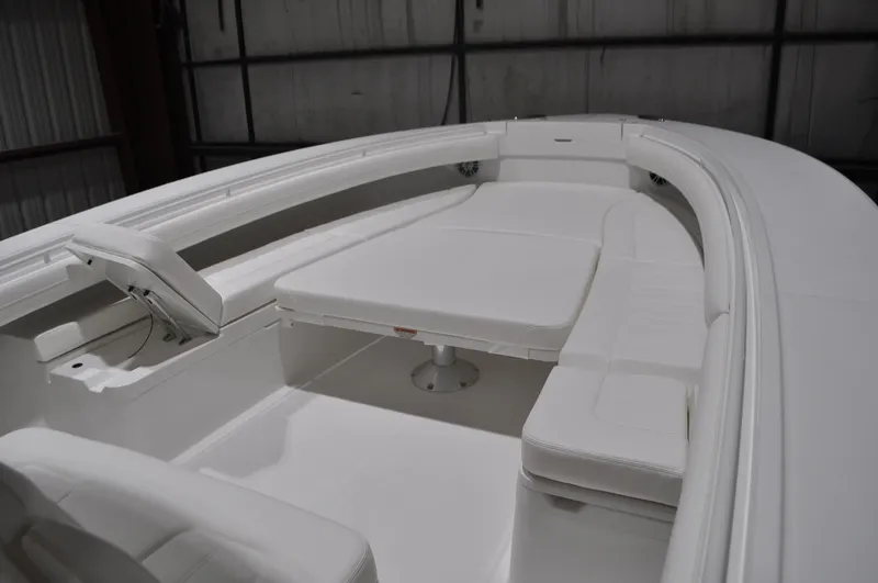 Slide: The Image of 2023 Regulator 34 boat interior with white seating and table in a spacious layout. - 5