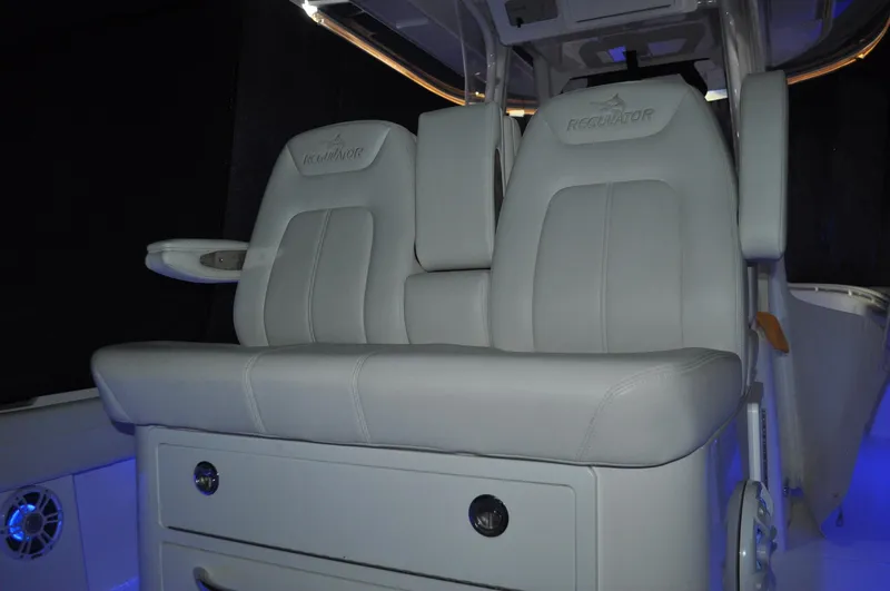 Slide: The Image of 2023 Regulator 34 boat interior with luxurious seating and ambient blue lighting. - 7