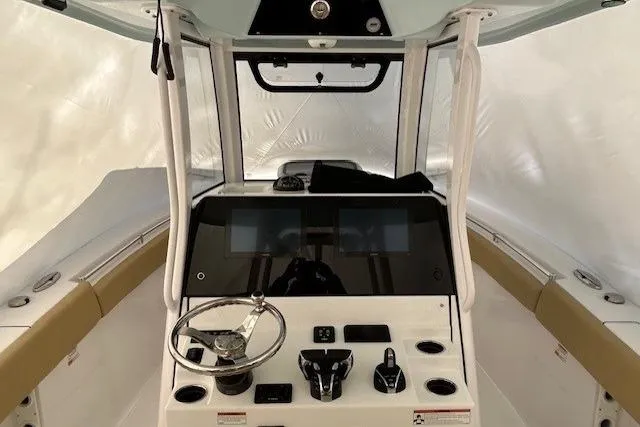Slide: The Image of 2023 Sportsman Open 282 Center Console boat interior with modern dashboard and steering wheel. - 35