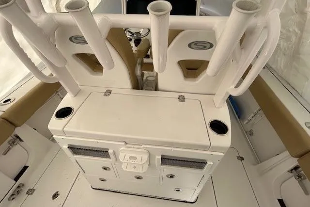Slide: The Image of 2023 Sportsman Open 282 Center Console interior with rod holders and storage compartments. - 38