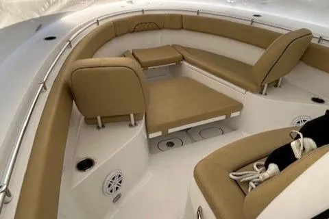 Slide: The Image of 2023 Sportsman Open 282 Center Console boat interior with tan seating and white deck. - 40