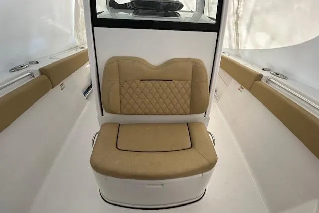 Slide: The Image of 2023 Sportsman Open 282 Center Console interior with tan seating and white accents. - 42