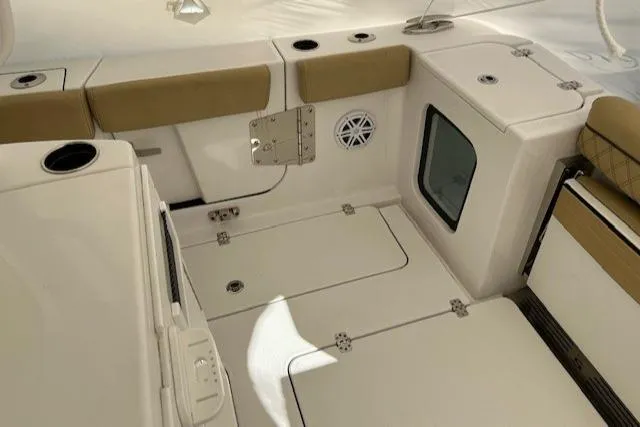 Slide: The Image of 2023 Sportsman Open 282 Center Console boat interior with cushioned seating and storage compartments. - 47