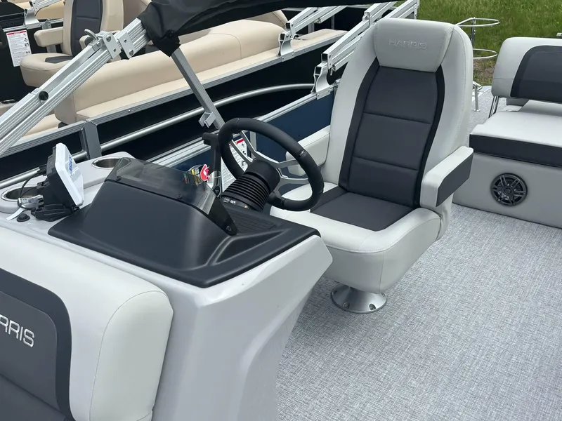 Slide: The Image of 2025 Harris Cruiser 210 SL boat interior with steering wheel and comfortable seating. - 10
