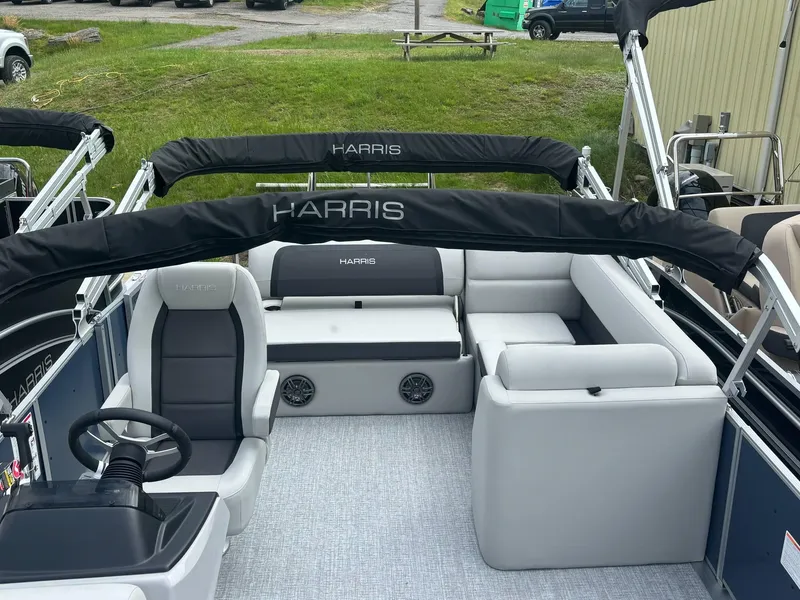 Slide: The Image of 2025 Harris Cruiser 210 SL pontoon boat interior with seating and steering wheel. - 11