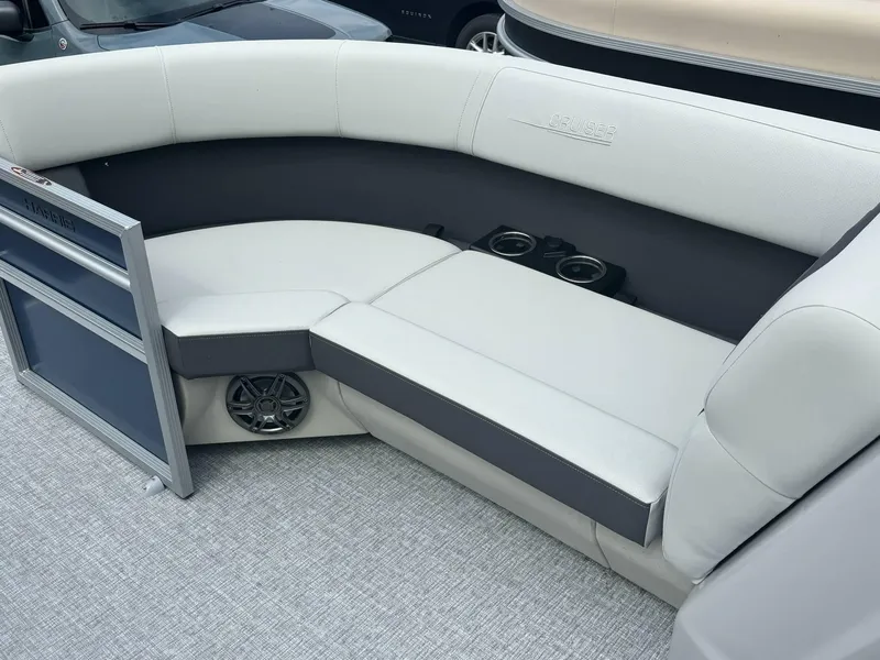 Slide: The Image of 2025 Harris Cruiser 210 SL boat interior with cushioned seating and cup holders. - 13