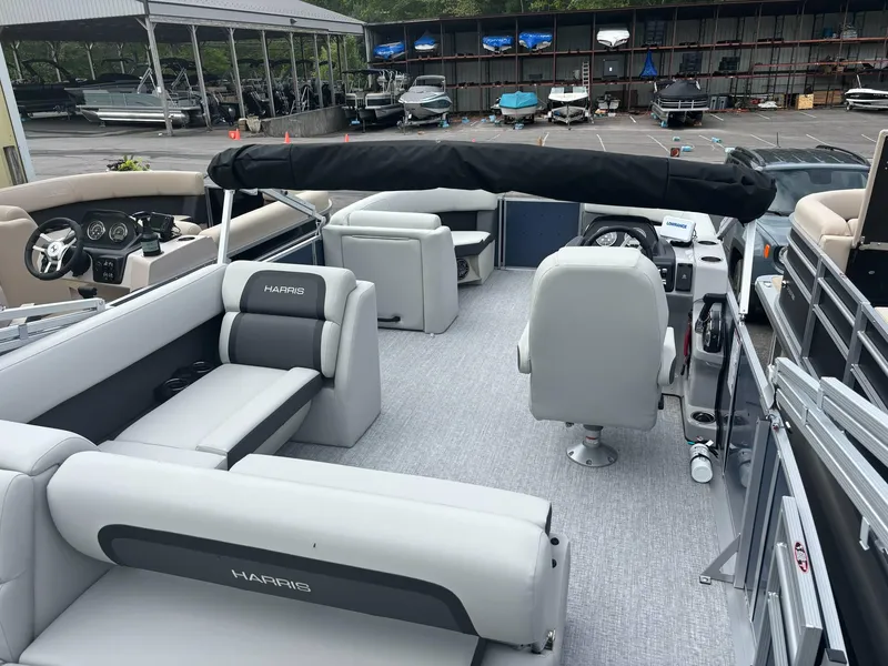 Slide: The Image of 2025 Harris Cruiser 210 SL pontoon boat with spacious seating and modern design. - 8