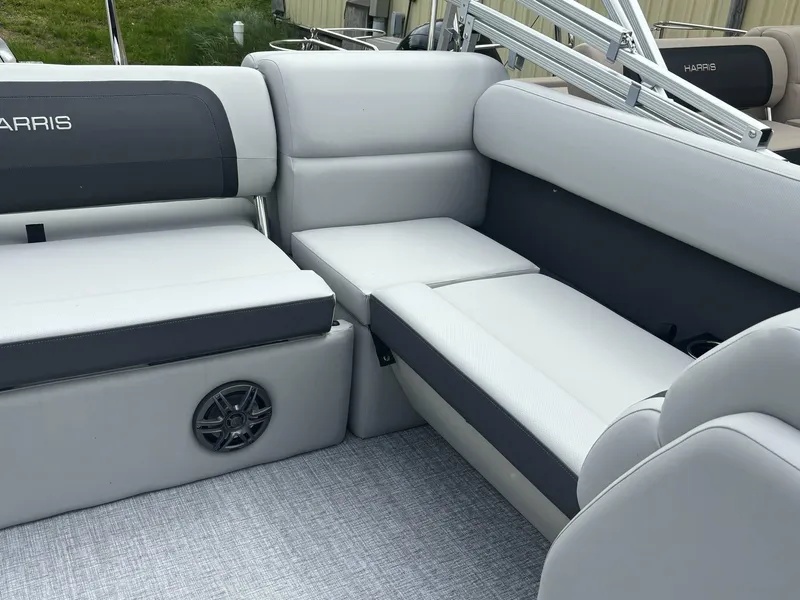 Slide: The Image of 2025 Harris Cruiser 210 SL interior with gray seating and speaker detail. - 9