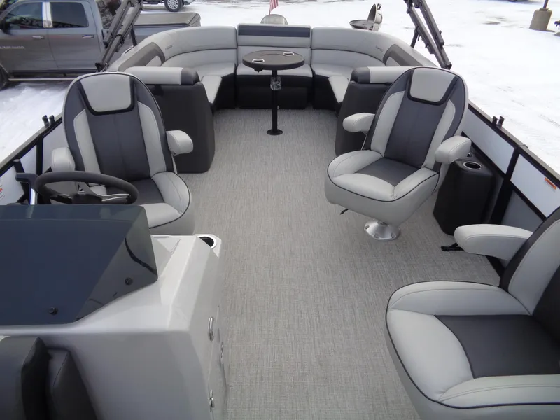Slide: The Image of 2023 Viaggio LAGO V 22E pontoon boat interior with gray seating and steering console. - 11