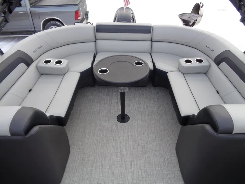 Slide: The Image of Luxurious seating area on 2023 Viaggio LAGO V 22E pontoon boat with cup holders and table. - 13