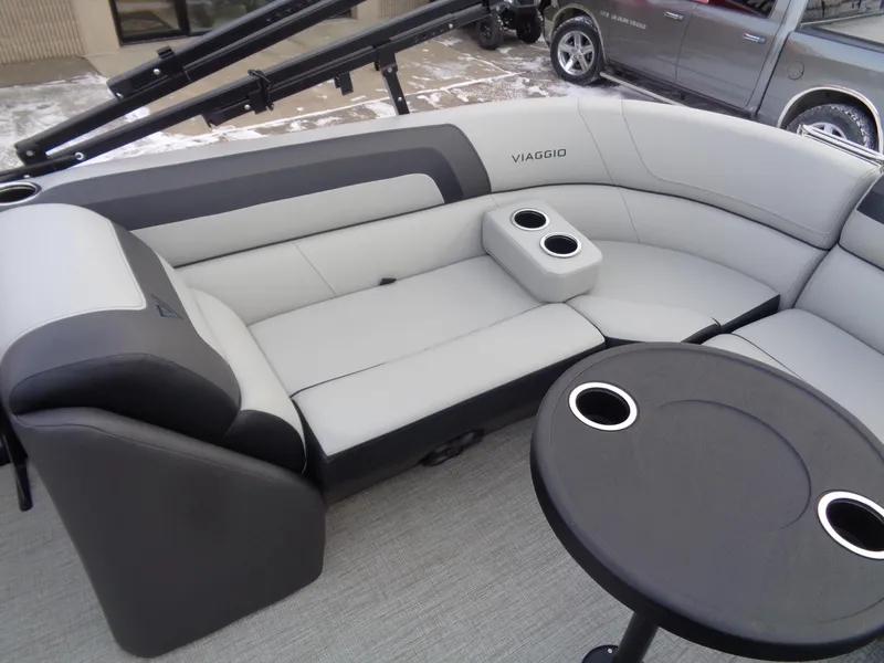 Slide: The Image of 2023 Viaggio LAGO V 22E boat interior with gray seating and cup holders. - 14