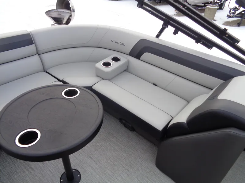 Slide: The Image of 2023 Viaggio LAGO V 22E boat interior with gray seating and round table. - 15