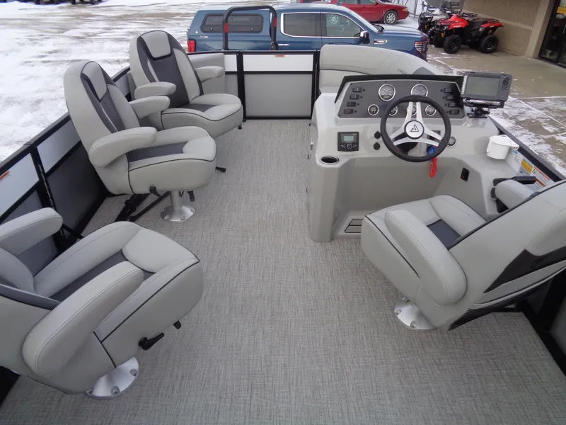 Slide: The Image of 2023 Viaggio LAGO V 22E pontoon boat interior with gray seating and modern dashboard. - 16