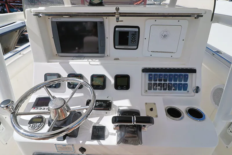 Slide: The Image of Control panel of a 2004 Marlago 35 Sport Cuddy boat with steering wheel and gauges. - 11