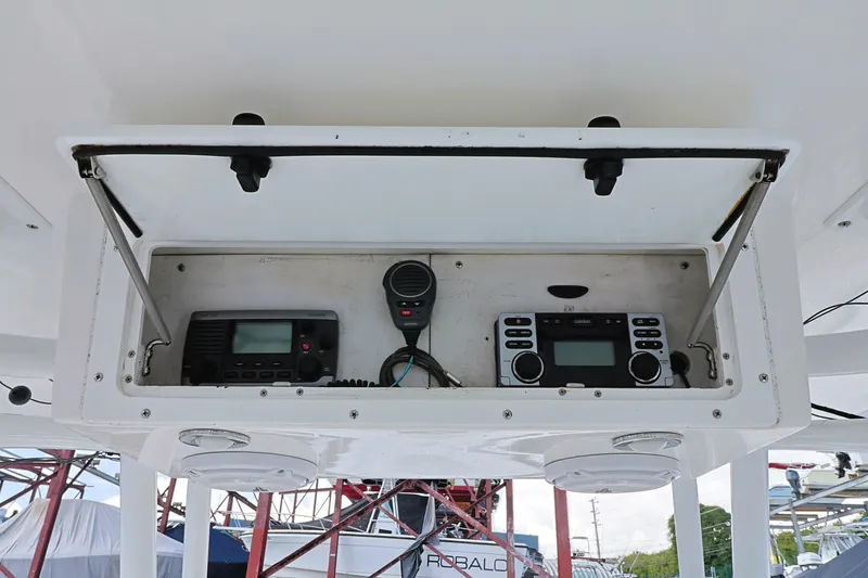 Slide: The Image of 2004 Marlago 35 Sport Cuddy boat dashboard with radio and control panel. - 12