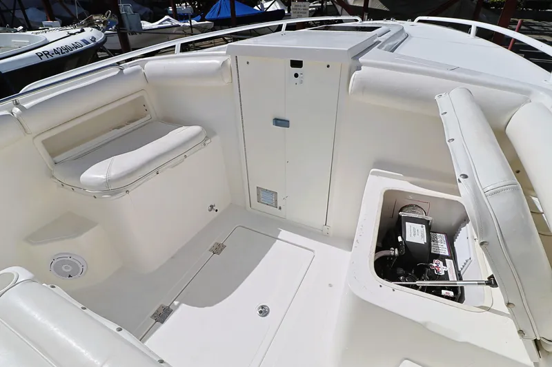 Slide: The Image of 2004 Marlago 35 Sport Cuddy boat interior with seating and storage compartments. - 17