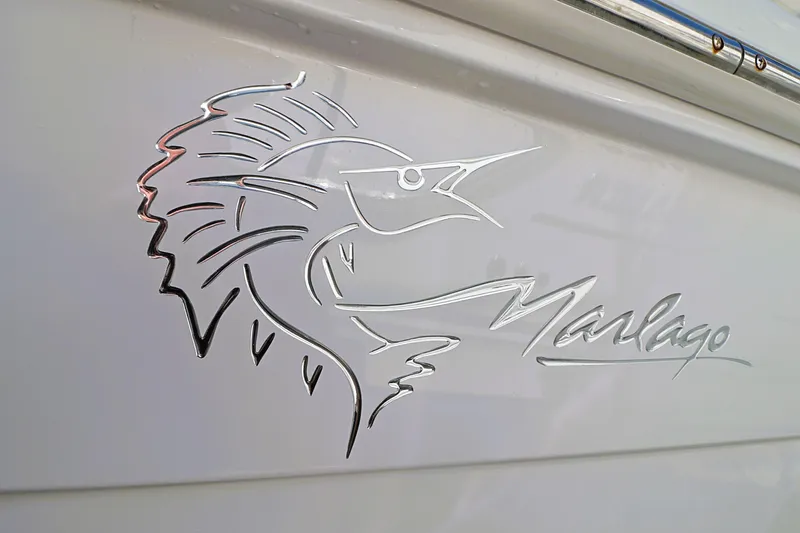 Slide: The Image of Chrome marlin logo on 2004 Marlago 35 Sport Cuddy boat. - 22