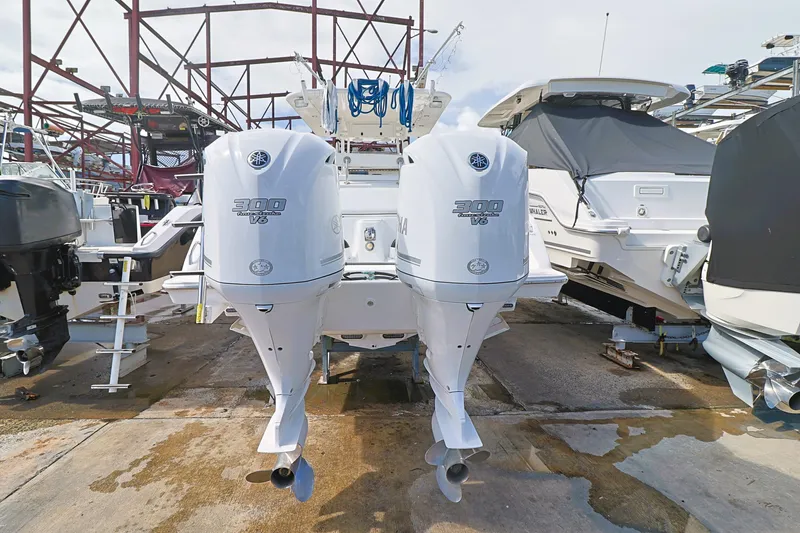 Slide: The Image of 2004 Marlago 35 Sport Cuddy with twin outboard engines in a marina. - 3