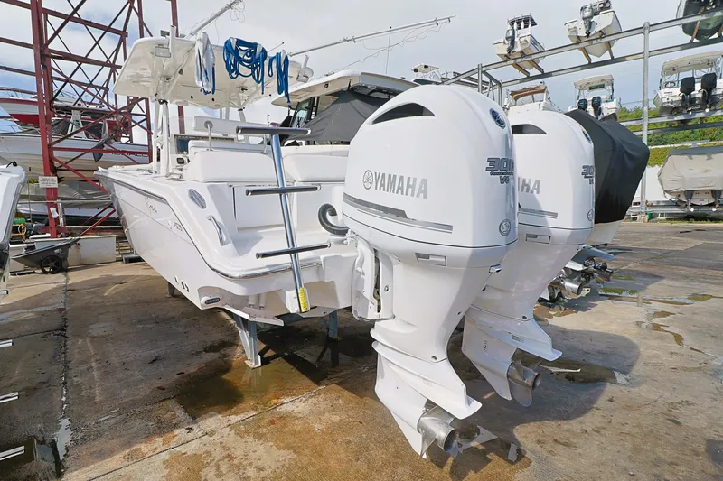 Slide: The Image of 2004 Marlago 35 Sport Cuddy with twin Yamaha outboard engines on a dock. - 4