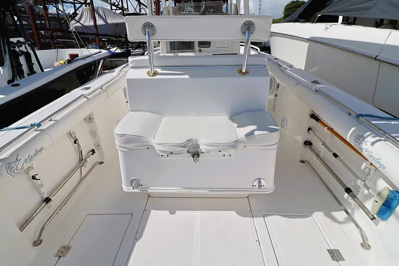 Slide: The Image of 2004 Marlago 35 Sport Cuddy boat interior with seating and storage. - 9
