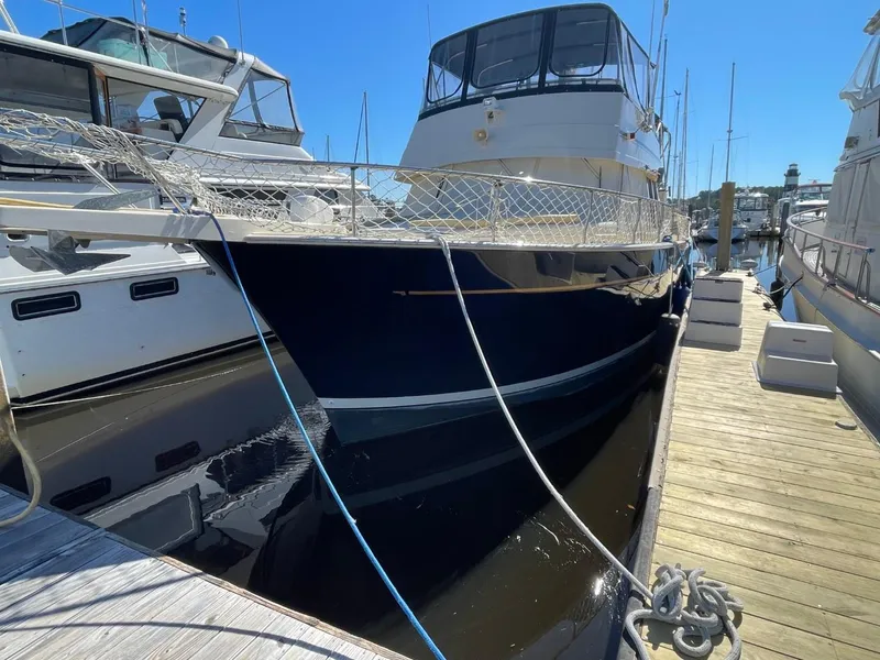 Slide: The Image of 2005 Mainship 430 Aft Cabin 3SR Trawler docked at marina, side view. - 10