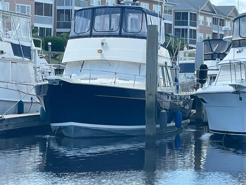 Slide: The Image of 2005 Mainship 430 Aft Cabin 3SR Trawler docked at marina. - 2
