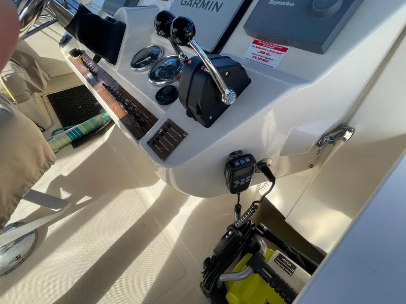 Slide: The Image of 2005 Mainship 430 Aft Cabin Trawler helm with controls and navigation equipment. - 20