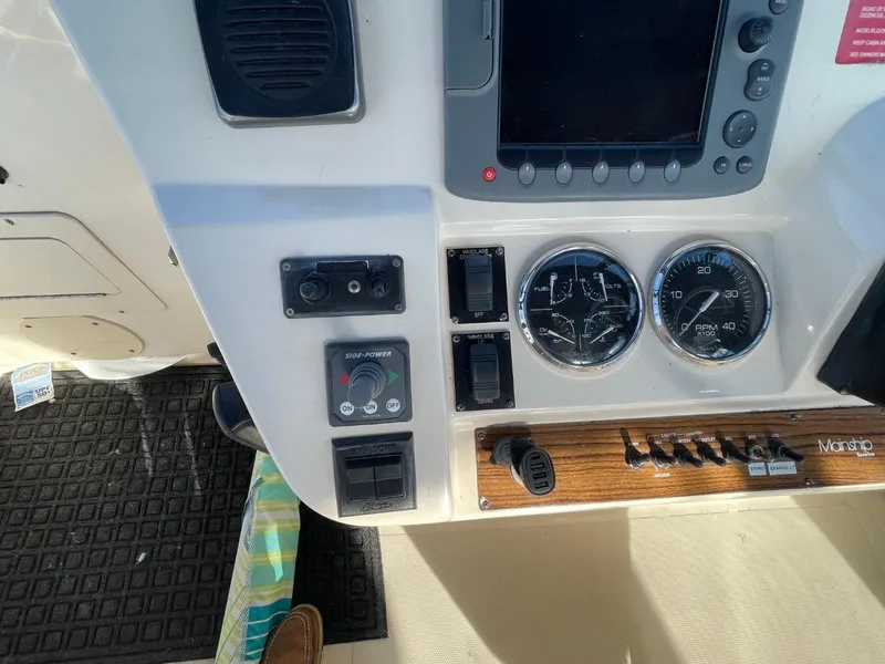Slide: The Image of Control panel of 2005 Mainship 430 Aft Cabin 3SR Trawler with gauges and switches. - 22