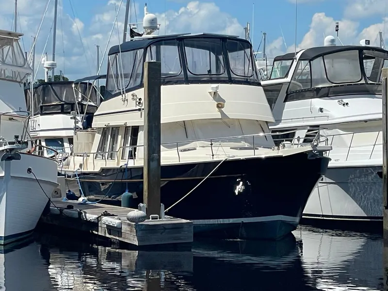Slide: The Image of 2005 Mainship 430 Aft Cabin 3SR Trawler docked at marina. - 3