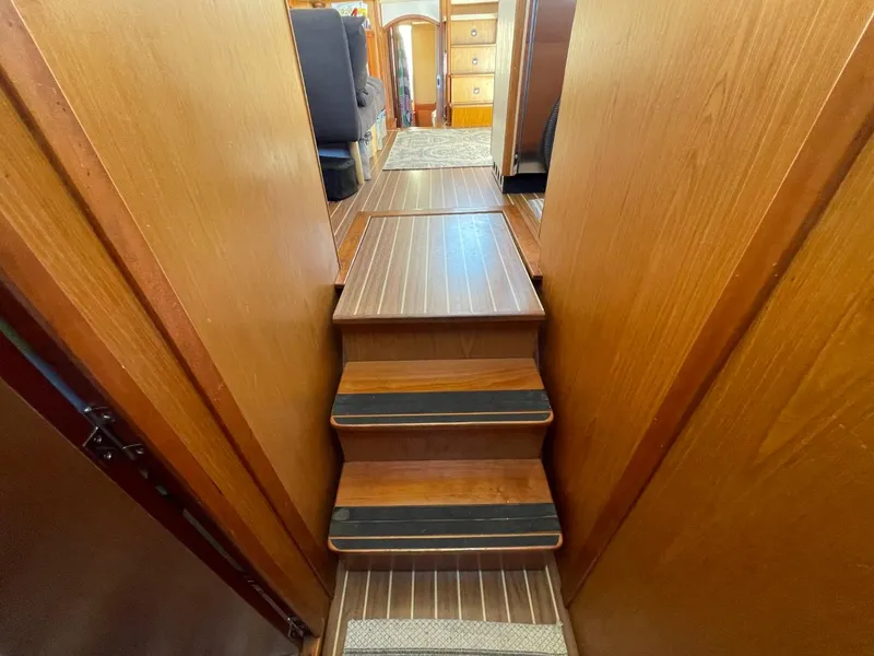 Slide: The Image of Stairway inside 2005 Mainship 430 Aft Cabin 3SR Trawler with wooden steps and hallway view. - 43