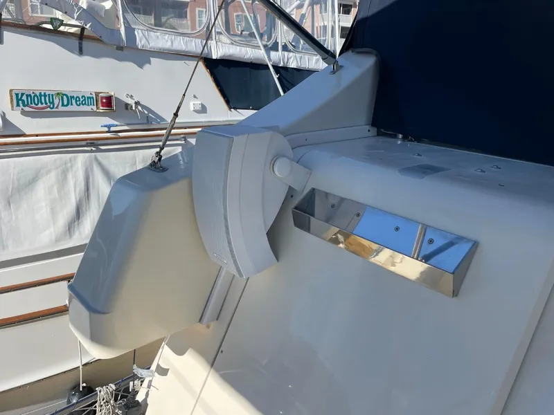Slide: The Image of 2005 Mainship 430 Aft Cabin Trawler, exterior detail with nearby boat, "Knotty Dream." - 48