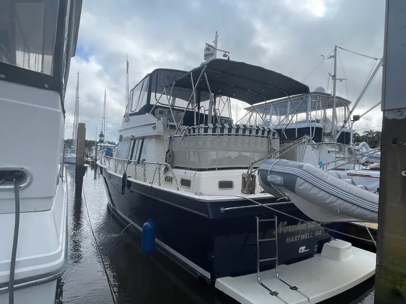 Slide: The Image of 2005 Mainship 430 Aft Cabin 3SR Trawler docked at marina, overcast sky. - 6